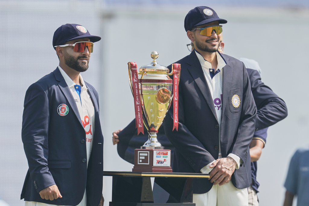 Afghanistan's captain Hashmatullah Shahidi, left, and India's captain Shubman Gill pose with the winners' trophy before the start of play on day one of the cricket test match between Afghanistan and India in New Chandigarh, India, Saturday, June 6, 2026. (AP Photo/Ashwini Bhatia)