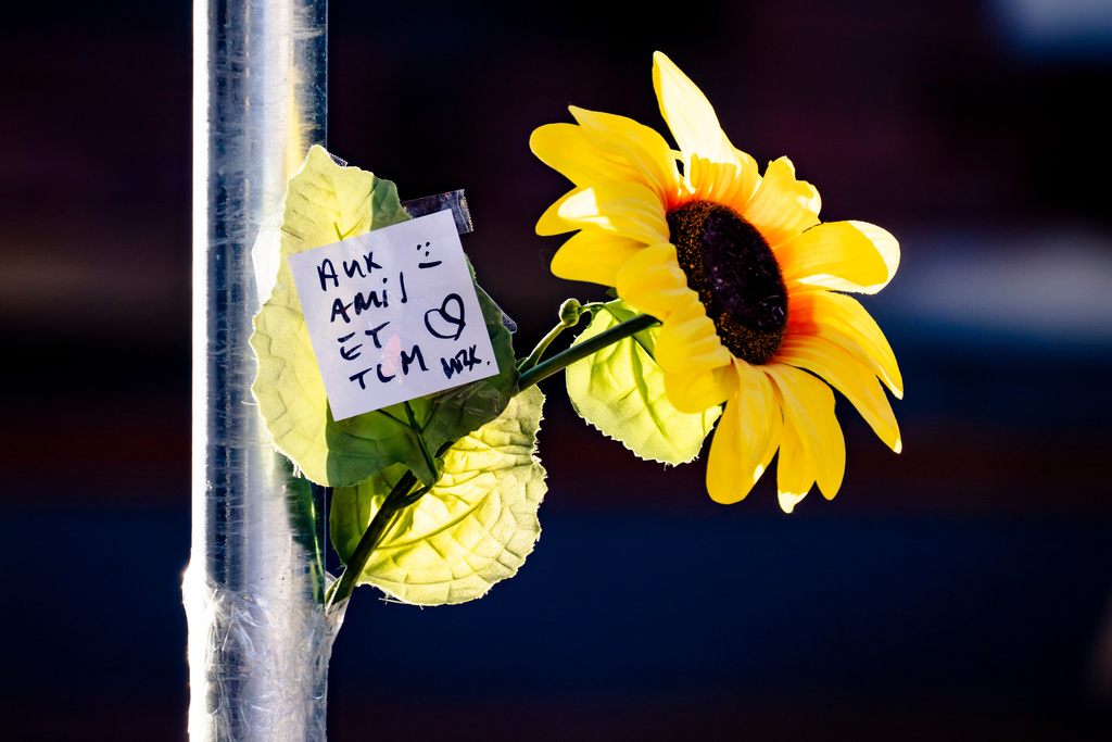 A floral tribute left near the area where a fire broke out at the Le Constellation bar and lounge during New Year's celebration, in Crans-Montana, Switzerland, Thursday, Jan. 1, 2026. (Jean-Christophe Bott/Keystone via AP)