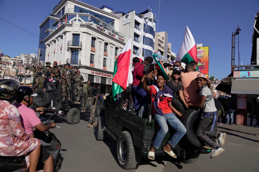 Troops loyal to CAPSAT military unit commander Col. Michael Randrianirina make their way to the Presidency to announce that the armed forces are taking control of the country in Antananarivo, Madagascar, Tuesday, Oct. 14, 2025. (AP Photo/ Brian Inganga)
