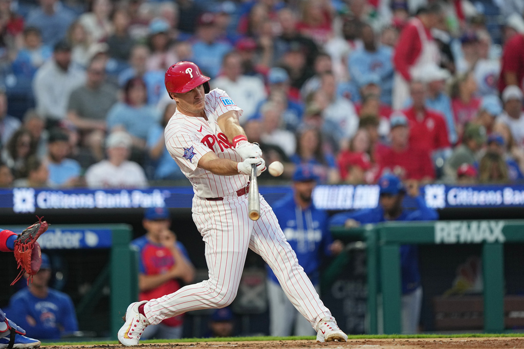 Philadelphia Phillies' J.T. Realmuto hits a one-run single off of Chicago Cubs pitcher Javier Assad during the second inning of a baseball game, Monday, April 13, 2026, in Philadelphia. (AP Photo/Matt Rourke)