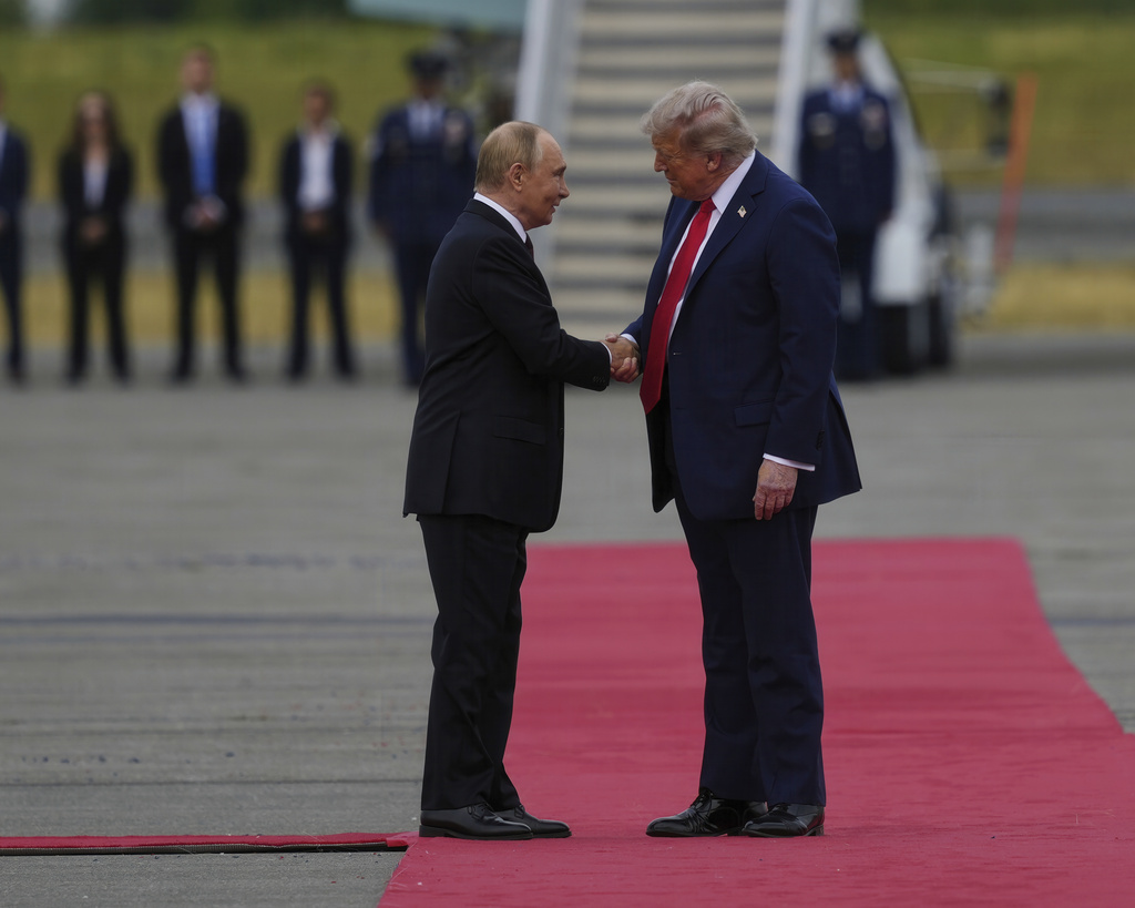 President Donald Trump greets Russia's President Vladimir Putin Friday, Aug. 15, 2025, at Joint Base Elmendorf-Richardson, Alaska. (AP Photo/Julia Demaree Nikhinson)