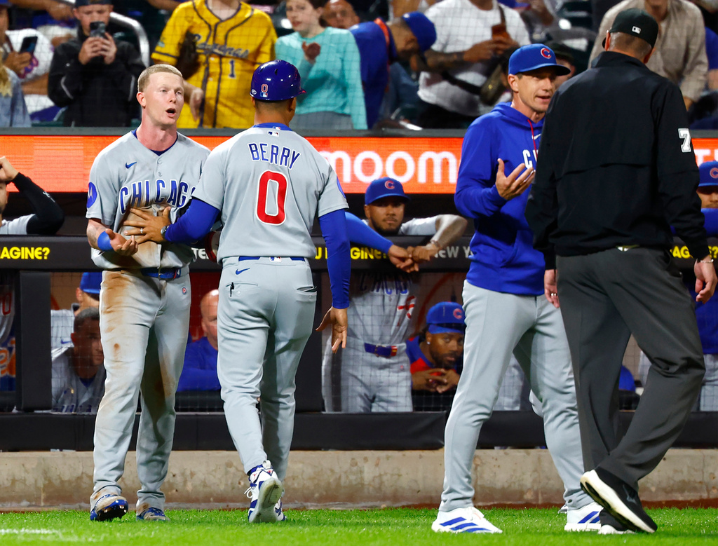 Chicago Cubs' center fielder Pete Crow-Armstrong, left, and manager Craig Counsell, right, argue with umpire Jordan Baker (71) during the seventh inning of a baseball game against the New York Mets, Tuesday, June 23, 2026, in New York. (AP Photo/Noah K. Murray)