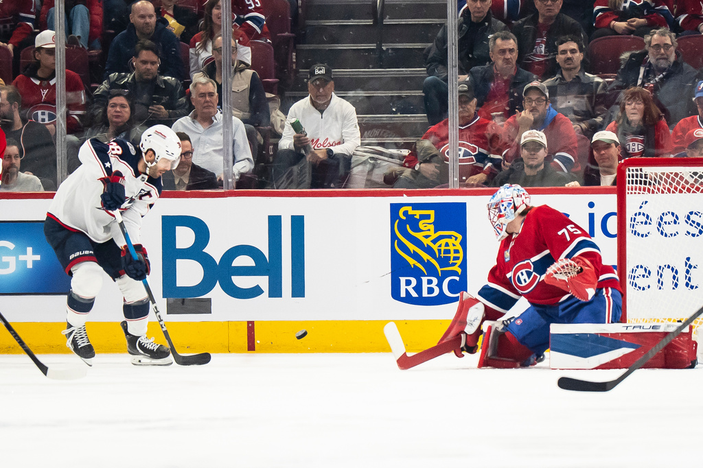 Columbus Blue Jackets' Boone Jenner (38) scores on Montreal Canadiens goaltender Jakub Dobes (75) during first period NHL hockey action, in Montreal on Saturday, April 11, 2026. (Christopher Katsarov/The Canadian Press via AP)
