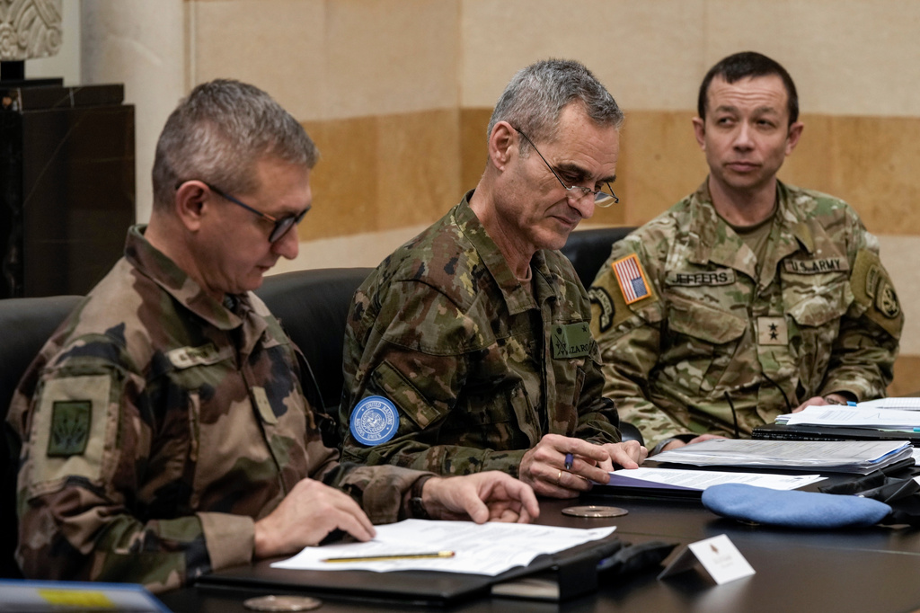 FILE - Members of the committee monitoring the Lebanon-Israel ceasefire, the Head of Mission and Force Commander of the United Nations Interim Force in Lebanon (UNIFIL), Major General Aroldo Lazaro Saenz, of Spain, center, US Maj. Gen. Jasper Jeffers, right, and Gen. Guillaume Ponchamp, of France, left, meet with Lebanese caretaker Prime Minister Najib Mikati, at the government palace in Beirut, Dec. 24, 2024. (AP Photo/Bilal Hussein, File)