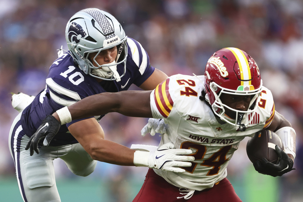 Kansas State Logan Bartley, left, tries to tackle Iowa State Abu Sama III during an NCAA college football game between Iowa State and Kansas State in Dublin, Ireland Saturday, Aug. 23, 2025. (AP Photo/Peter Morrison)