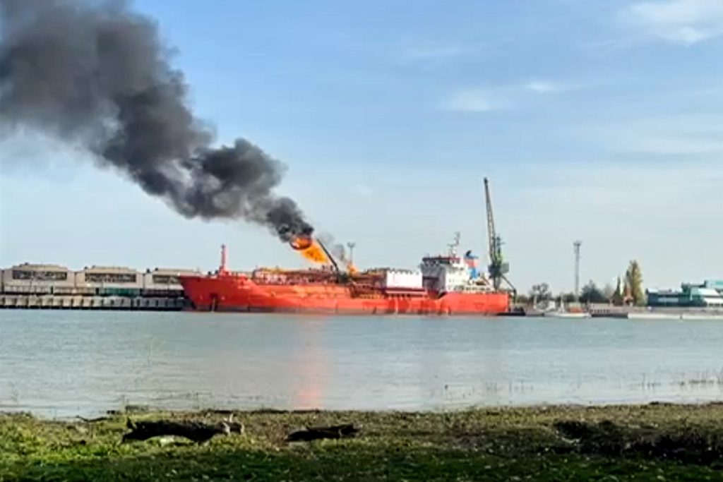 This image released on Monday, Nov. 17, 2025 by Romania's Emergency services, ISU, shot from the Romanian side of the border on the Danube river, shows a cargo ship loaded with liquified petroleum gas engulfed by flames following Russian strikes on Ukrainian port infrastructure in Izmail, Ukraine. (ISU Tulcea via AP)