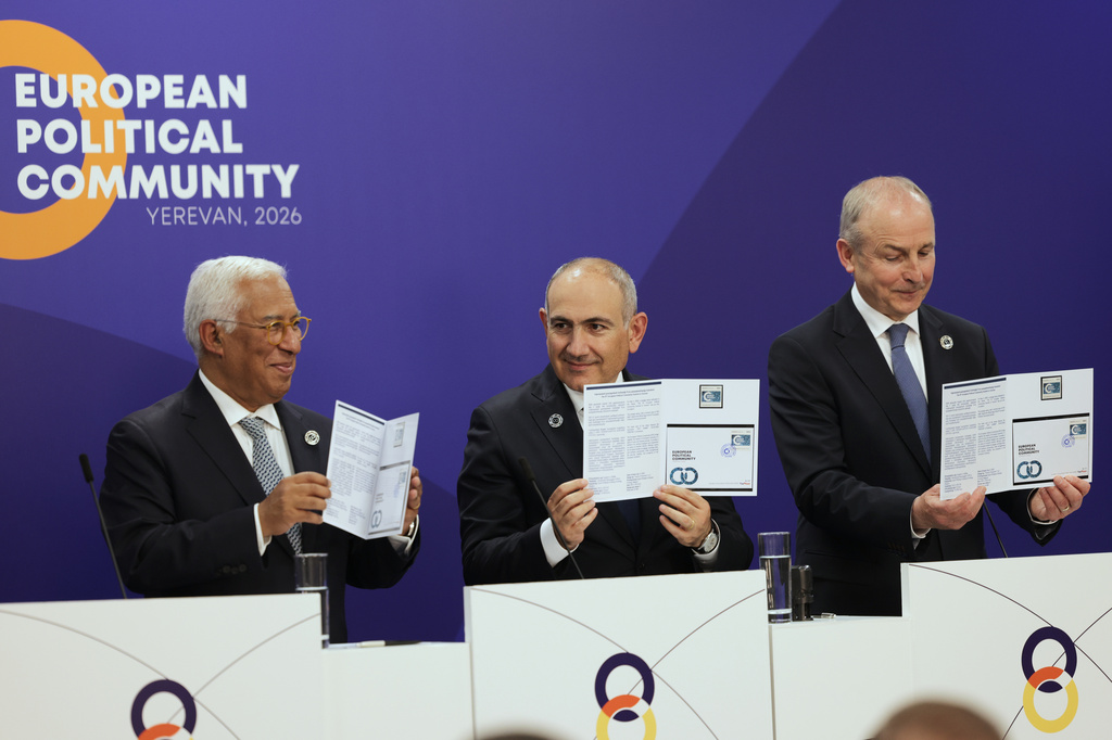 From left, European Council President Antonio Costa, Armenia's Prime Minister Nikol Pashinyan and Ireland's Prime Minister Micheál Martin hold up a commemorative stamp as they participate in a media conference during a meeting of the European Political Community in Yerevan, Armenia, Monday, May 4, 2026. (AP Photo/Anthony Pizzoferrato)
