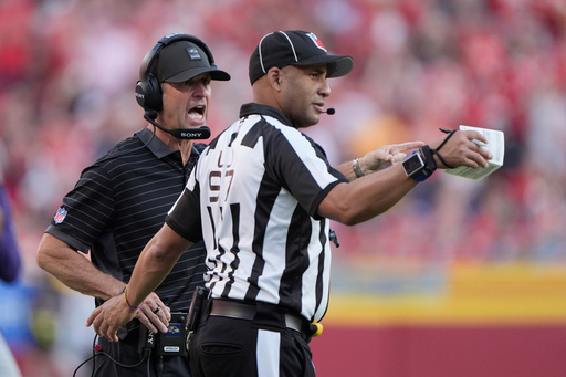 Baltimore Ravens head coach Jim Harbaugh, left, talks on the sideline with line judge Brian Perry (97) during the second half of an NFL football game against the Kansas City Chiefs Sunday, Sept. 28, 2025, in Kansas City, Mo. (AP Photo/Charlie Riedel) Baltimore Ravens head coach Jim Harbaugh, left, talks on the sideline with line judge Brian Perry (97) during the second half of an NFL football game against the Kansas City Chiefs Sunday, Sept. 28, 2025, in Kansas City, Mo. (AP Photo/Charlie Riedel)