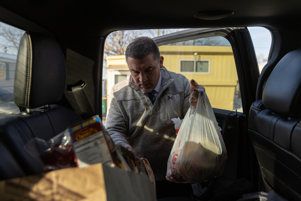 Valley View Elementary School principal Jason Kuhlman delivers food donations to families from the school Tuesday, Feb. 3, 2026, in Columbia Heights, Minn. (AP Photo/Liam James Doyle)