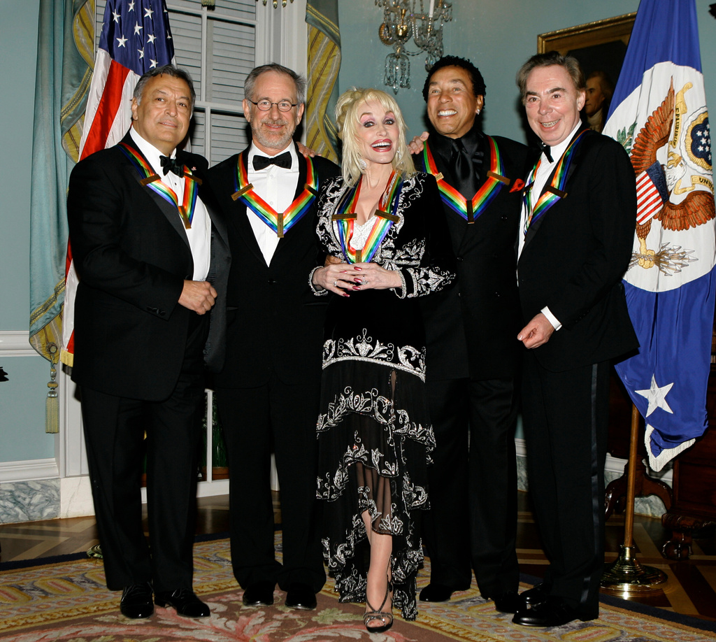 FILE - Dolly Parton, center, stands with other 2006 Kennedy Center honorees being celebrated for their contributions to American culture at the State Department in Washington, Dec. 2, 2006. From left are Zubin Mehta, Steven Spielberg, Dolly Parton, Smokey Robinson, and Andrew Lloyd Webber. (AP Photo/J. Scott Applewhite, File) Corrects spelling of Spielberg's first name to Steven.