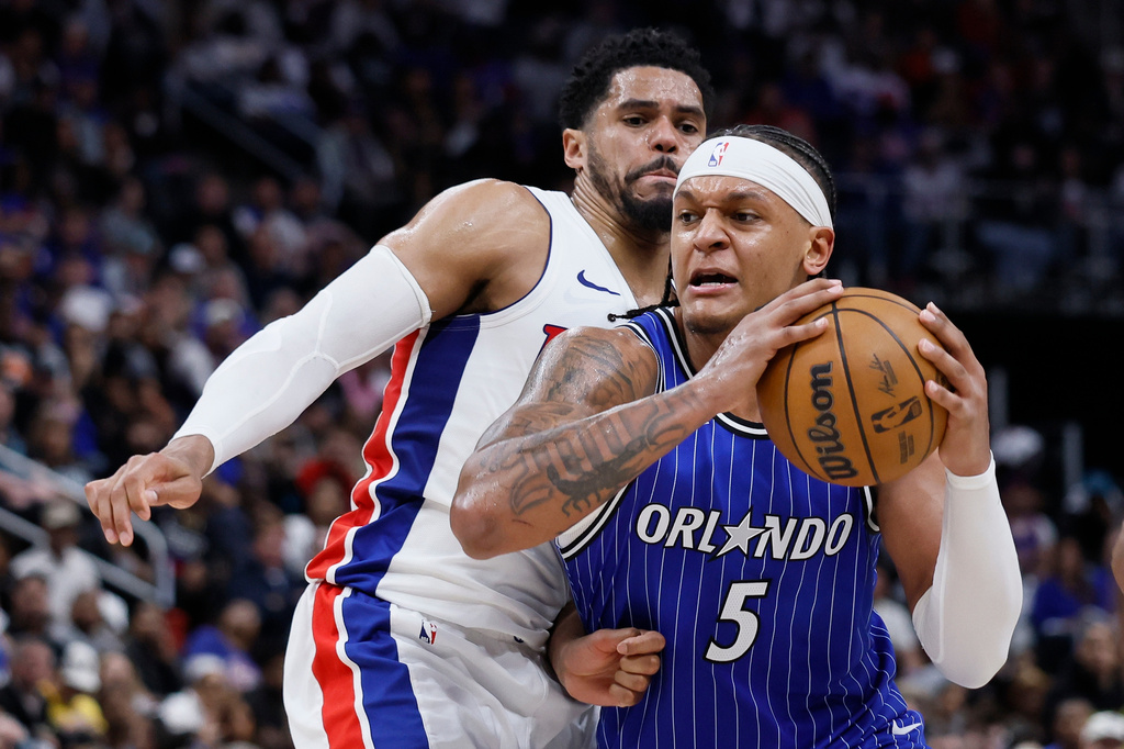 Orlando Magic forward Paolo Banchero (5) drives to the basket against Detroit Pistons forward Tobias Harris, left, during the second half in Game 7 of a first-round NBA basketball playoffs series Sunday, May 3, 2026, in Detroit. (AP Photo/Duane Burleson)