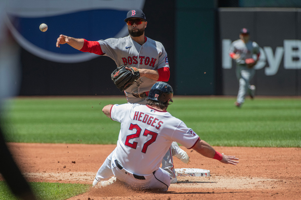 Boston Red Sox's Isiah Kiner-Falefa, top, forces out Cleveland Guardians' Austin Hedges (27) at second base and throws to first base for a double play during the second inning of a baseball game, Sunday, May 31, 2026, in Cleveland. (AP Photo/Phil Long)