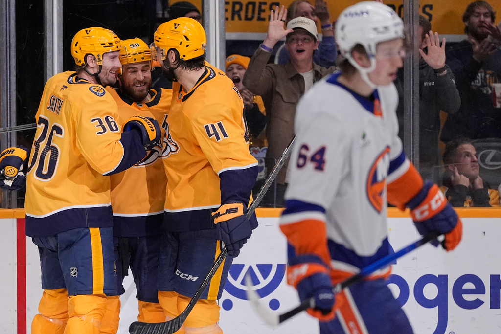 Nashville Predators center Ryan O'Reilly, second from left, celebrates his a short-handed goal with left wing Cole Smith (36) and defenseman Nicolas Hague (41) during the second period of an NHL hockey game against the New York Islanders, Thursday, Jan. 8, 2026, in Nashville, Tenn. (AP Photo/George Walker IV)