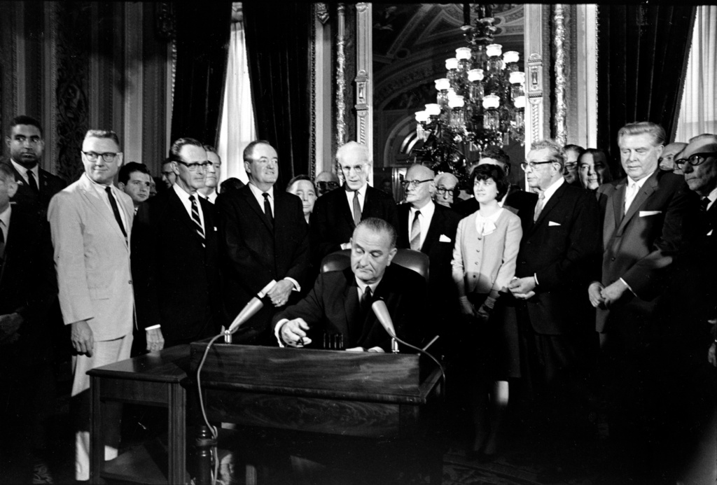 FILE - President Lyndon B. Johnson signs the Voting Rights Act of 1965 on Aug. 6, 1965, in a ceremony in the President's Room at the U.S. Capitol in Washington. (AP Photo, File)