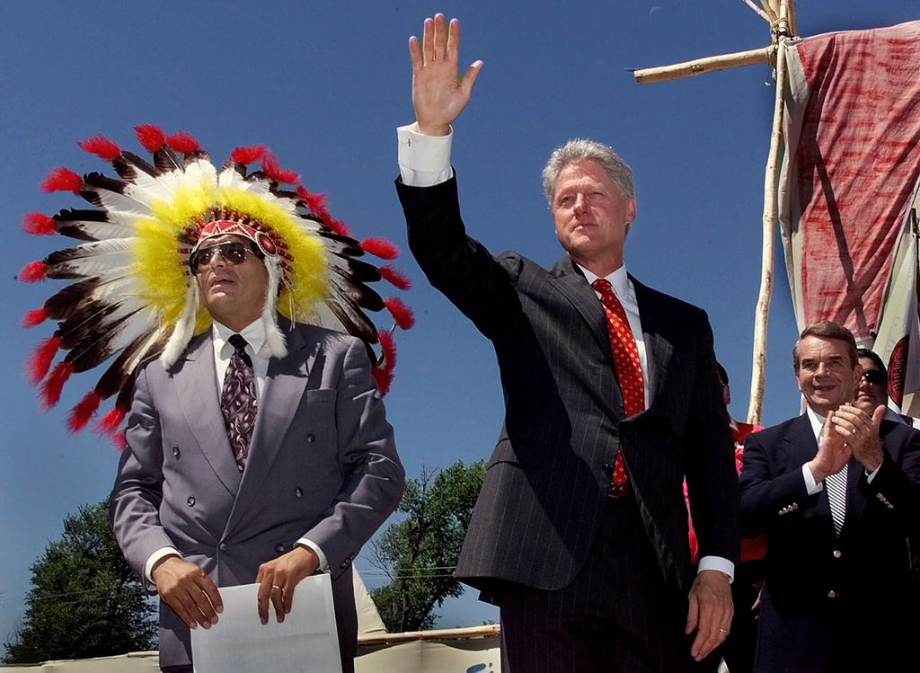 FILE - President Clinton waves as he takes the stage with Harold Salway, tribal president of the Oglala Sioux nation Wednesday, July 7, 1999 on the Pine Ridge Indian Reservation in S.D. (AP Photo/J. Scott Applewhite,File)