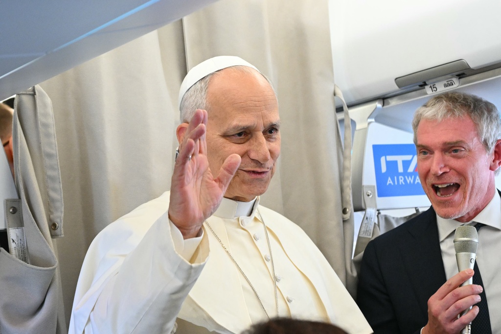 Pope Leo XIV talks to reporters aboard an aircraft on his way to Beirut, Lebanon, Sunday, Nov. 30, 2025. (Andreas Solaro/Pool Via AP)