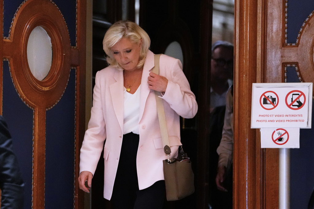 Far-right leader Marine Le Pen leaves the courtroom after the verdict of her appeal trial, in Paris, France, Tuesday, July. 7, 2026. (AP Photo/Aurelien Morissard)