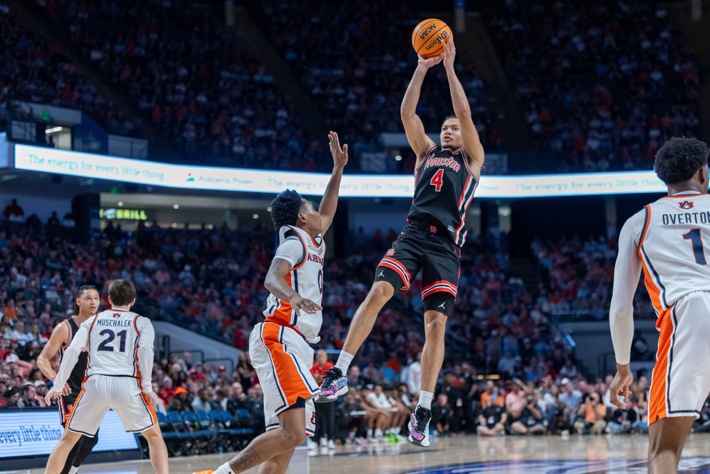 Houston guard Kingston Flemings (4) shoots over Auburn guard Tahaad Pettiford during the first half of an NCAA college basketball game, Sunday, Nov. 16, 2025, in Birmingham, Ala. (AP Photo/Vasha Hunt)