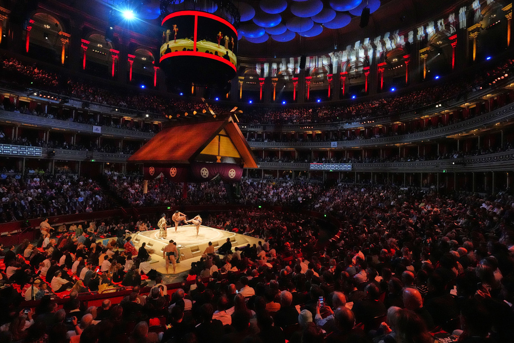 Sumo wrestlers, called rikishi, prepare for their bouth on the dohyo, the sacred sumo wrestling ring, during The Grand Sumo Tournament at the Royal Albert Hall in London, Wednesday, Oct. 15, 2025.(AP Photo/Frank Augstein)