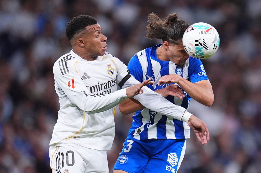 Real Madrid's Kylian Mbappe, left, and Alaves' Youssef Enriquez fight for the ball during a La Liga soccer match between Real Madrid and Alaves in Madrid, Spain, Tuesday, April 21, 2026. (AP Photo/Manu Fernandez)