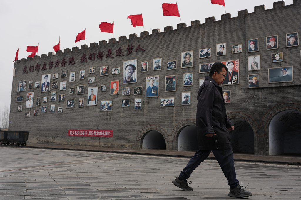 A man walks past a wall of fame for mine workers at the Jinhuagong National Mine Park, a museum converted from a former section of the No. 9 mine, in Datong, China on Friday, March 13, 2026. (AP Photo/Ng Han Guan)