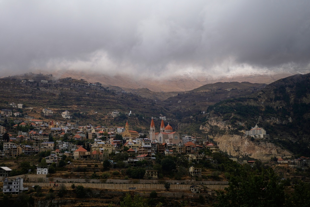Clouds hang low over the mountain village of Bcharre, home to several historic churches and monasteries in northern Lebanon, Saturday, Nov. 15, 2025. (AP Photo/Hassan Ammar)