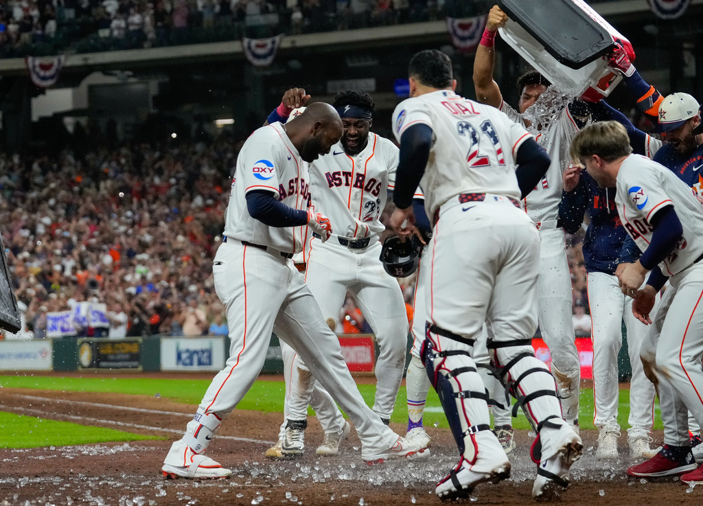 Houston Astros designated hitter Yordan Alvarez, left, celebrates with teammates at home after hitting a two-run walkoff home run during the ninth inning of a baseball game against the Tampa Bay Rays in Houston, Saturday, July 4, 2026. (AP Photo/Jon Shapley)