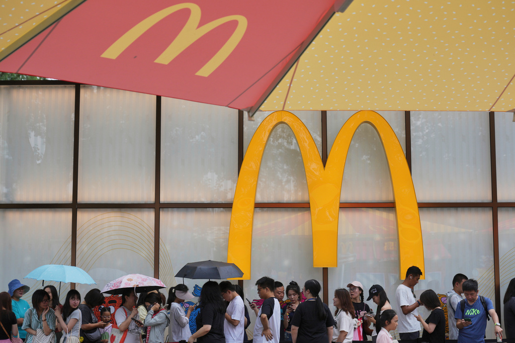 FILE - People line up to enter a McDonald's restaurant in Beijing on Aug. 20, 2025. (AP Photo/Andy Wong, File)