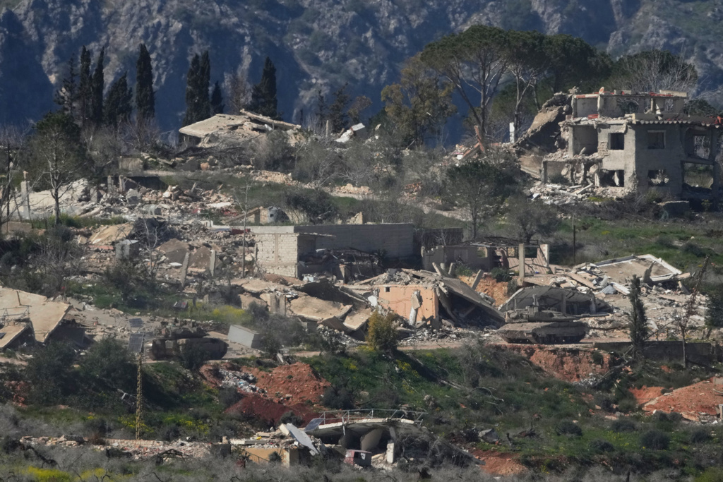 An Israeli tank maneuvers in southern Lebanon near the border with Israel, Sunday, March 8, 2026. (AP Photo/Ariel Schalit)