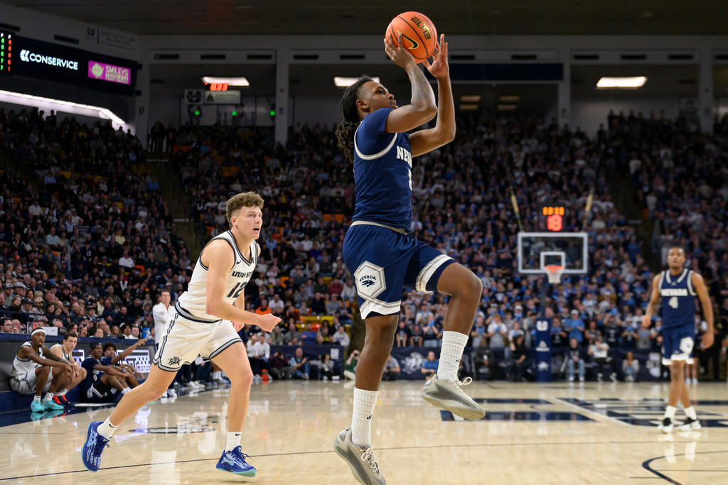 Nevada guard Vaughn Weems, center, shoots during the first half of an NCAA college basketball game against Utah State, Wednesday, Jan. 14, 2026, in Logan, Utah. (AP Photo/Tyler Tate)