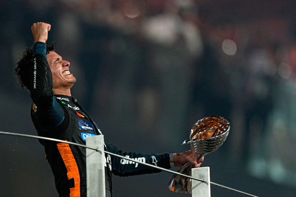 McLaren driver Lando Norris of Britain celebrates after becoming a world champion after the Formula One Abu Dhabi Grand Prix at the Yas Marina Circuit in Abu Dhabi, UAE, Sunday, Dec. 7, 2025. (AP Photo/Fatima Shbair)