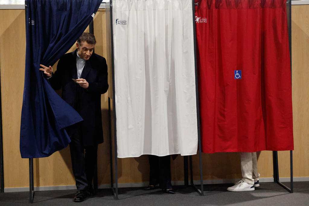 French President Emmanuel Macron leaves the voting booth before voting for the first round of France's municipal elections in Le Touquet-Paris-Plage, northern France, Sunday, March 15, 2026. (AP Photo/Jean-Francois Badias, Pool)