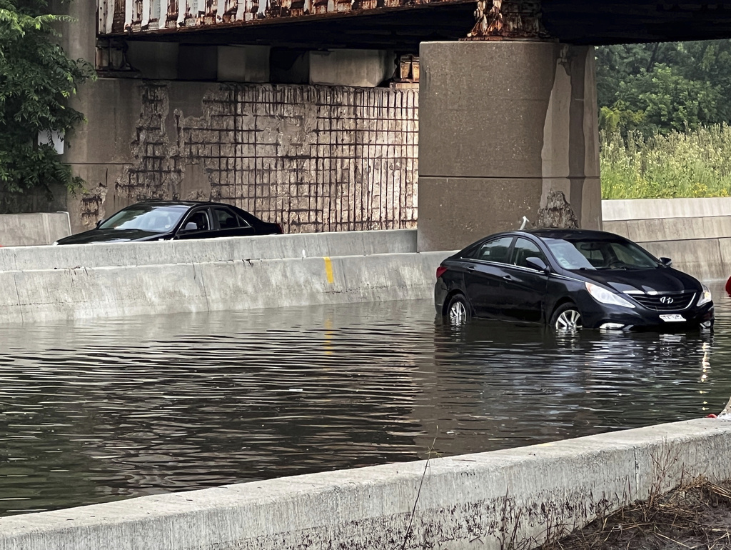 CORRECTION - CORRECTS SOURCE TO CBS58 NOT CBS28. This image provided by CBS58 (WDJT) shows idle cars in a flooded street in Milwaukee, Sunday, Aug. 10, 2025. (CBS58 (WDJT) via AP)