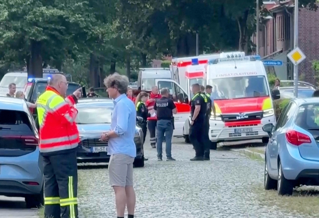In this image taken from a video, emergency responders, residents and police in Stade, Germany, Monday, June 29, 2026 after five people were killed in a shooting on Monday at a youth welfare facility in the northern German town of Stade, police said. (NWM-TV via AP)