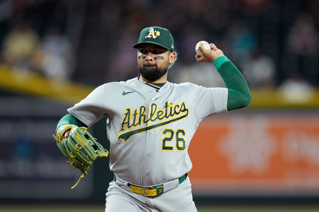 Athletics pitcher Carlos Cortes throws against the Arizona Diamondbacks during the eighth inning of a baseball game, Wednesday, July 22, 2026, in Phoenix. (AP Photo/Ross D. Franklin)