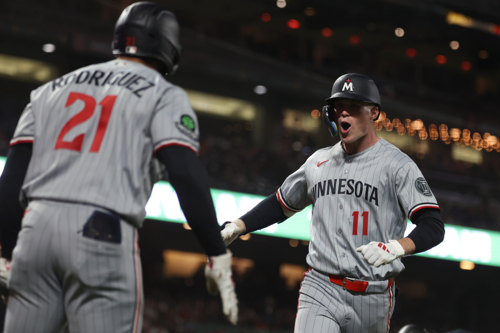 Minnesota Twins' Walker Jenkins (11) celebrates with Emmanuel Rodriguez (21) after hitting a home run during the seventh inning of a baseball game against the San Francisco Giants in San Francisco, Tuesday, Sept. 22, 2026. (AP Photo/Jed Jacobsohn)