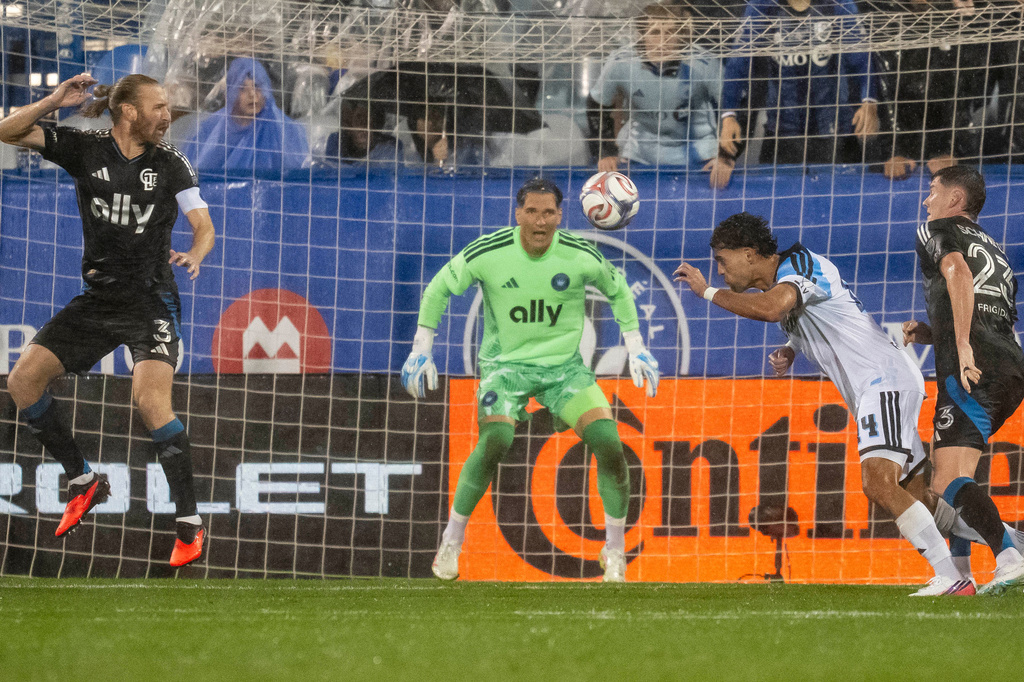 CF Montreal's Daniel Rios (second right) scores a header against Charlotte FC goalkeeper Kristijan Kahlina (1) during the first half of a MLS soccer game, in Montreal, Wednesday, Sept. 9, 2026. (Christopher Katsarov/The Canadian Press via AP)