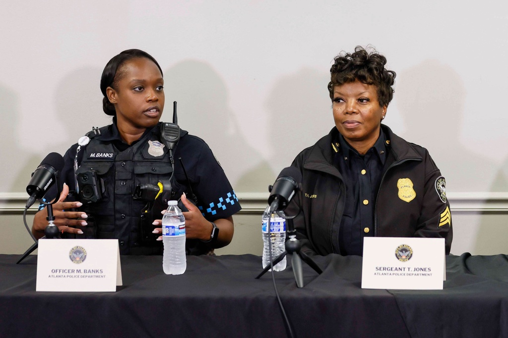Police officer Myasha Banks, left, along with Sargent Tywana Jones, explains the timeline of events from the time she encountered Billy Joel Cagle through his arrest and prevented a tragedy at Hartsfield-Jackson Atlanta International Airport during a press conference at the Atlanta Public Safety Headquarters on Tuesday, Oct. 21, 2025. (Miguel Martinez/Atlanta Journal-Constitution via AP)