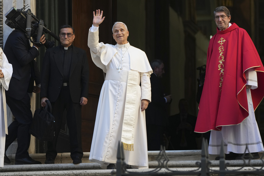 Pope Leo XIV waves flanked by Alejandro Moral Antón, Order of Saint Augustine prior, upon his arrivial at the St. Augustin Basilica in Rome, Monday, Sept. 1, 2025, to address his fellow Augustinians at the start of their global assembly. (AP Photo/Domenico Stinellis)