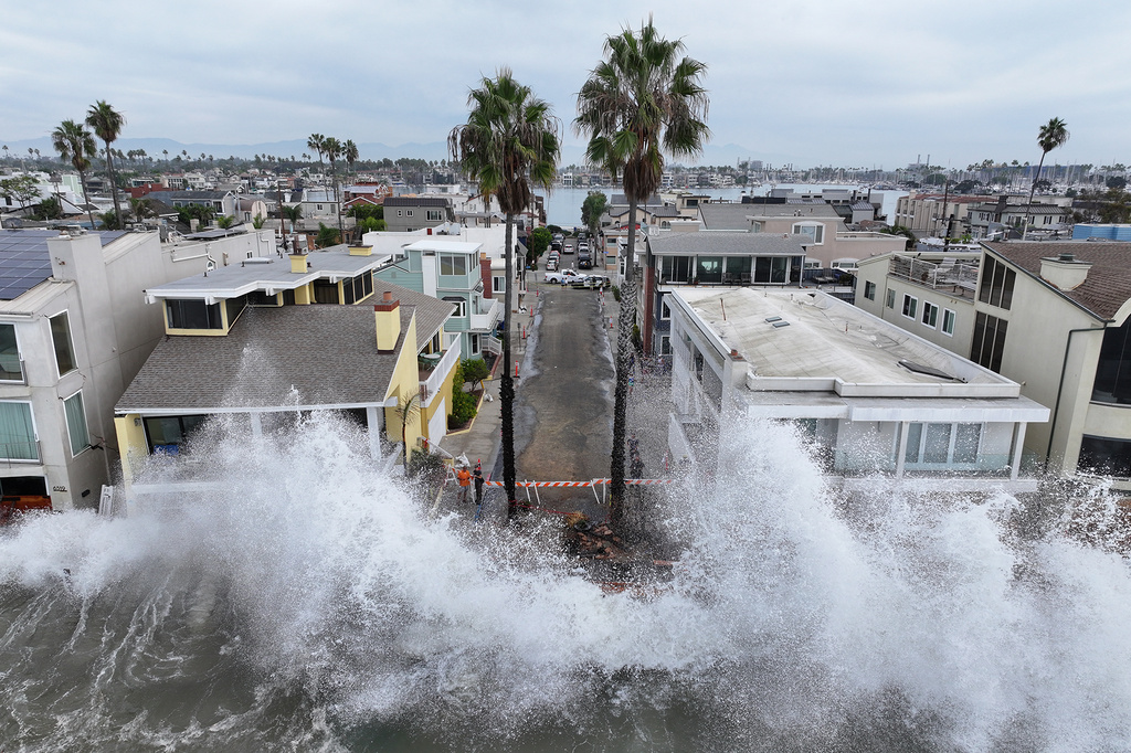 Waves hit a walkway in front of homes in Long Beach, Calif., Saturday, Oct. 10, 2026, as Tropical Storm Rachel approaches. (AP Photo/William Liang)