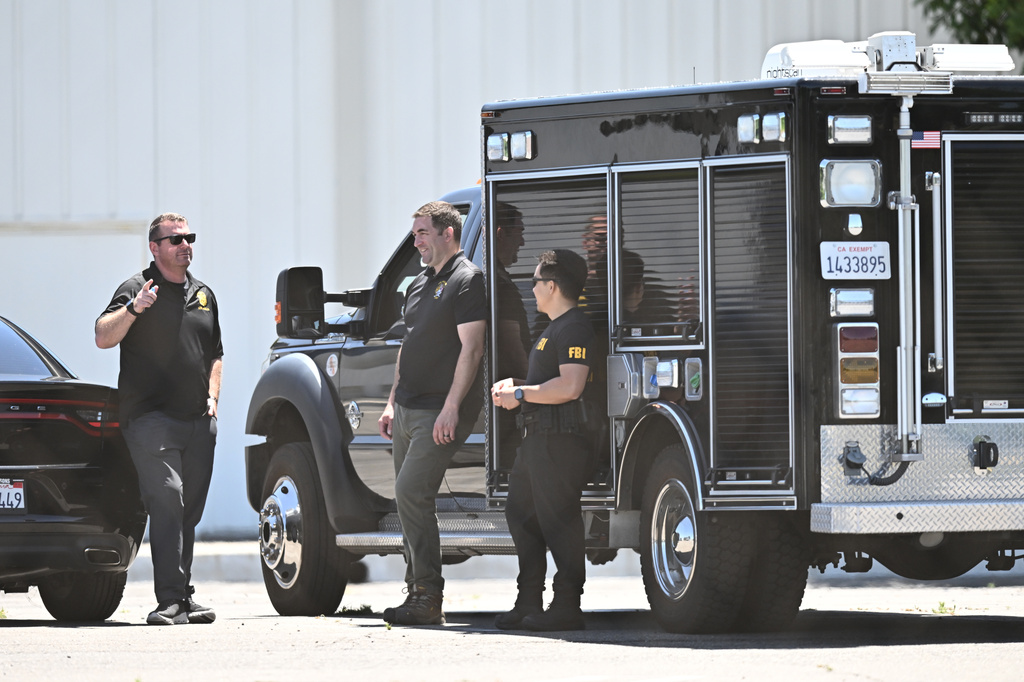 FBI agents stage at GKN Aerospace in Garden Grove, Calif. on Wednesday, June 10, 2026. (AP Photo/William Liang)