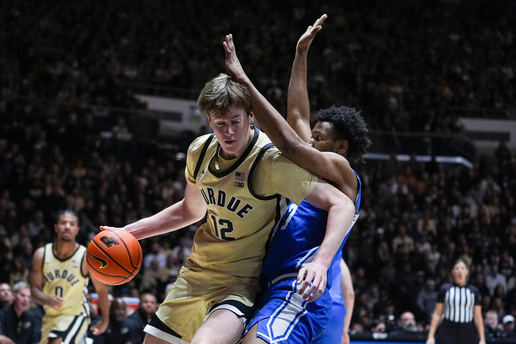 Purdue center Daniel Jacobsen (12) tries to get around Eastern Illinois forward Prince Johnson (7) during the second half of an NCAA college basketball game in West Lafayette, Ind., Friday, Nov. 28, 2025. (AP Photo/Michael Conroy)