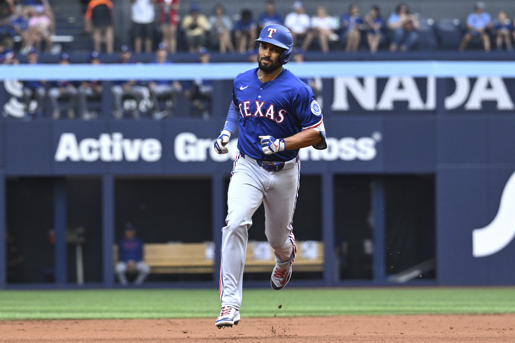 Texas Rangers' Marcus Semien runs the bases after hitting a two-run home run against the Toronto Blue Jays in second-inning baseball game action in Toronto, Sunday, Aug. 17, 2025. (Jon Blacker/The Canadian Press via AP)