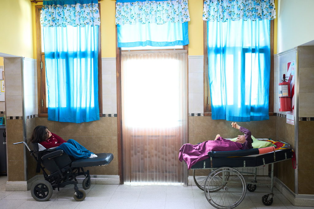 Residents gather in a communal area as they wait to fed at the Pequeño Cottolengo Don Orione, a home for people with disabilities that will be visited by Pope Leo XIV in November, in Buenos Aires, Argentina, Thursday, Sept. 24, 2026. (AP Photo/Rodrigo Abd)