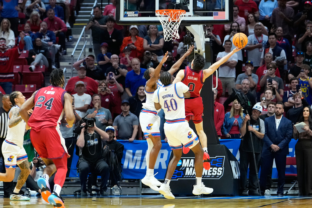 St. John's guard Dylan Darling (0) shoots with less than a second left against Kansas during the second half of a game in the second round of the NCAA college basketball tournament Sunday, March 22, 2026, in San Diego. (AP Photo/Mark J. Terrill)