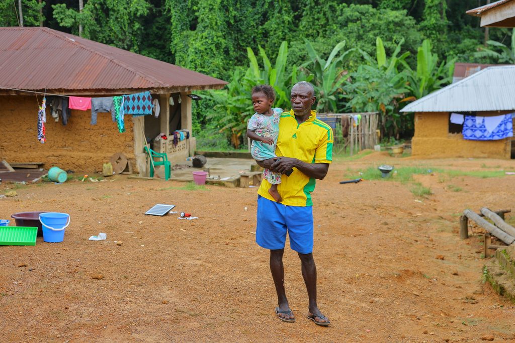 Boima G. Kamara, who has lived his entire life in Jikando, is preparing to relocate because mining pollution has poisoned the river his village depends on, July 8, 2025, in Jikando, Liberia. (AP Photo/Misper Apawu)