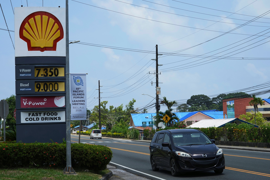 A car moves past a sign displaying gasoline and diesel prices in U.S. dollars per gallon during the Pacific Islands Forum Leaders Meeting in Koror, Palau, Sunday, Aug. 30, 2026. (AP Photo/Charlotte Graham-McLay)