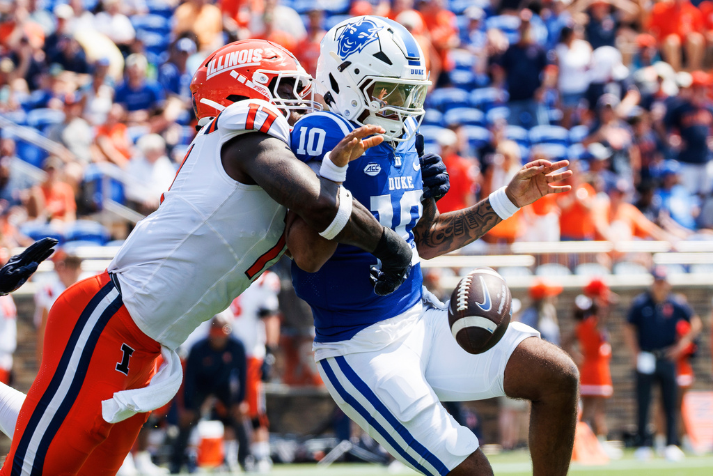 Duke's Darian Mensah (10) fumbles the ball as he is hit by Illinois' Gabe Jacas (17) during the first half of an NCAA college football game in Durham, N.C., Saturday, Sep. 6, 2025. (AP Photo/Ben McKeown)
