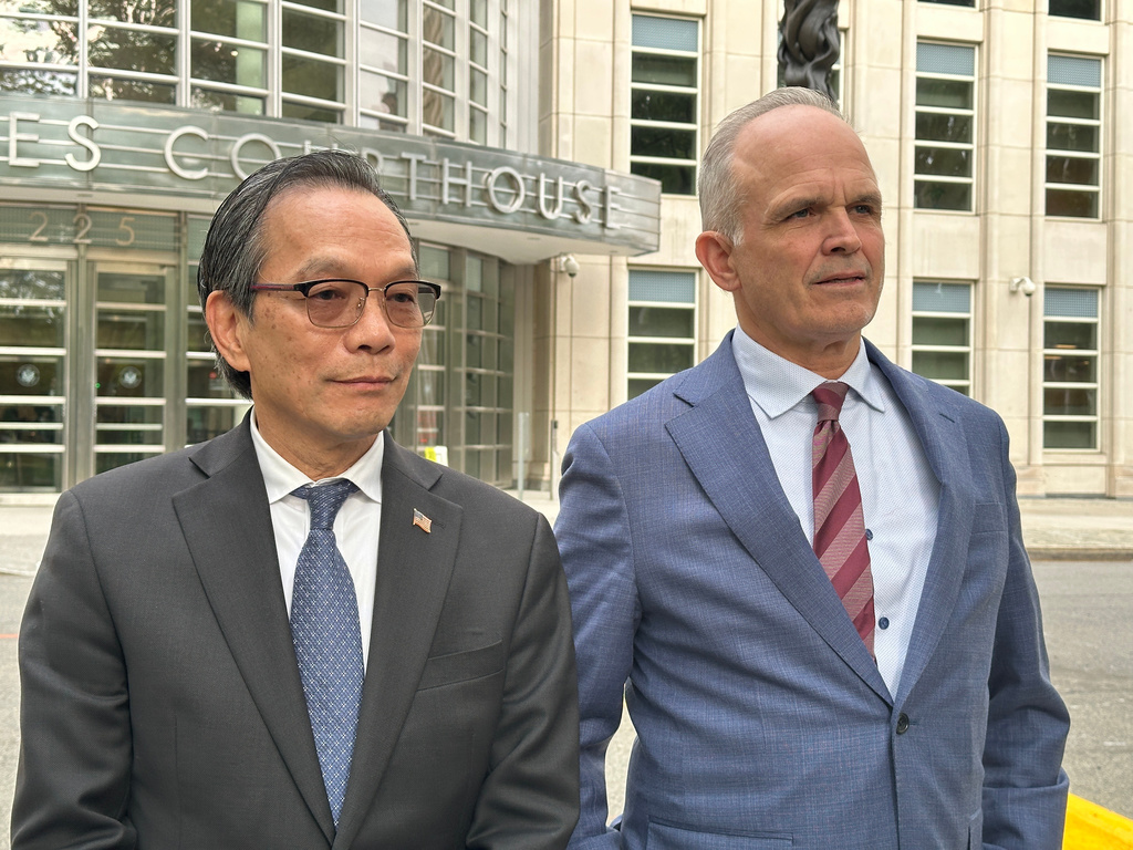 Lu Jianwang stands with his lawyer, John Carman, outside a U.S. courthouse in Brooklyn, New York, on Wednesday, May 13, 2026, following his conviction of acting as an illegal foreign agent for China. (AP Photo/Michael R. Sisak)