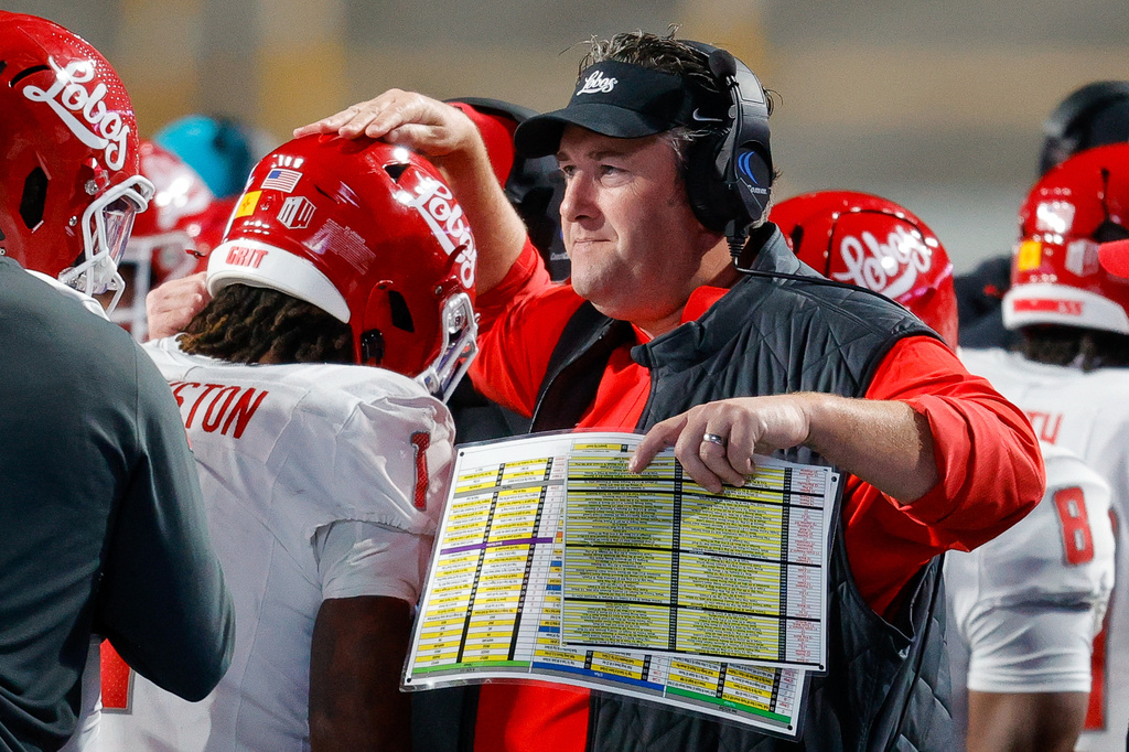 FILE - New Mexico head coach Jason Eck taps running back Damon Bankston (1) on the head after his long kickoff return for a touchdown in the first half of an NCAA college football game, Oct. 11, 2025, in Boise, Idaho. (AP Photo/Steve Conner, File)